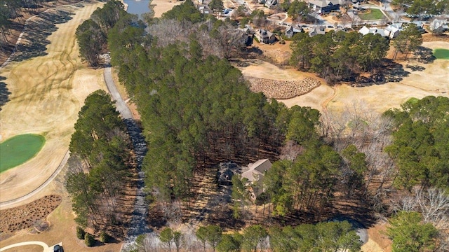 drone / aerial view featuring a wooded view