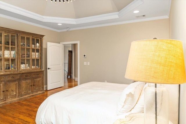 bedroom with ornamental molding, recessed lighting, dark wood-style flooring, and visible vents