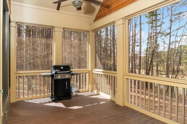 unfurnished sunroom featuring a ceiling fan and vaulted ceiling