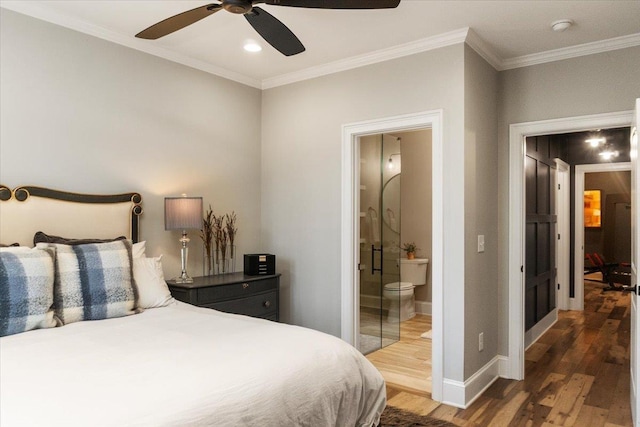 bedroom with crown molding, ensuite bath, baseboards, and wood finished floors