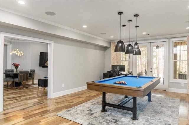 recreation room with light wood-style floors, baseboards, crown molding, and french doors