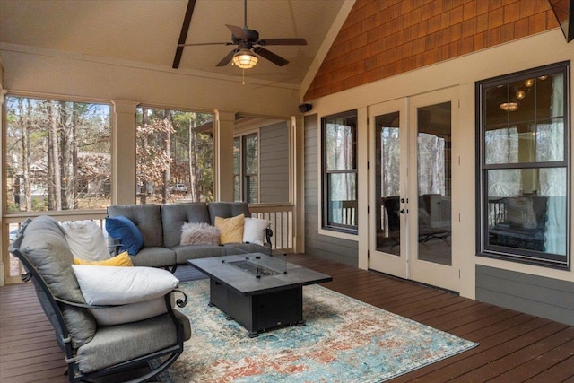 sunroom featuring vaulted ceiling and ceiling fan