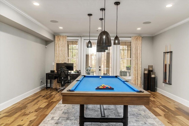 rec room with baseboards, ornamental molding, and wood finished floors