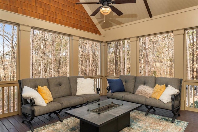 sunroom / solarium with a ceiling fan and lofted ceiling