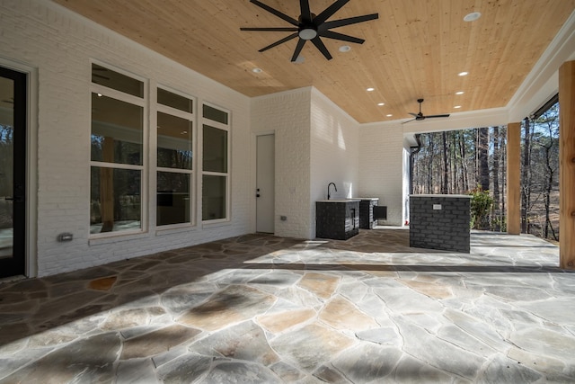 view of patio with exterior kitchen and ceiling fan