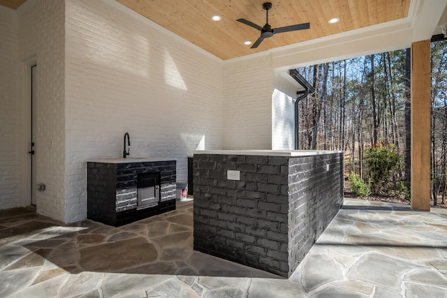 view of patio with ceiling fan and a sink