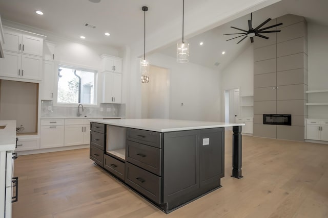 kitchen with light wood-style floors, visible vents, and white cabinetry