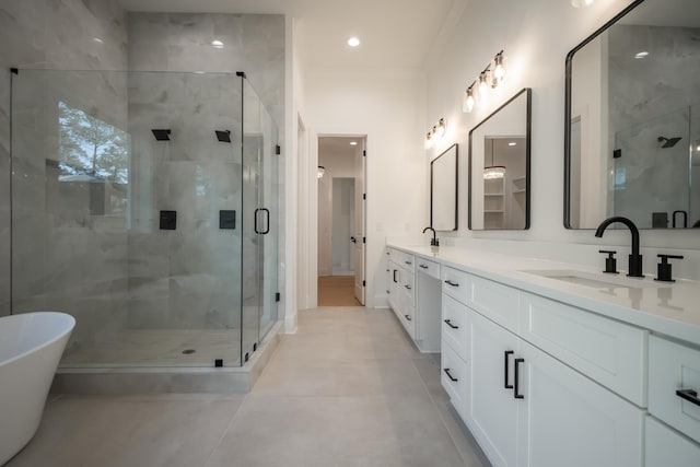 full bathroom featuring double vanity, a stall shower, a sink, and a soaking tub