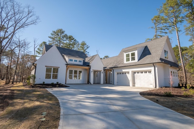 modern farmhouse with a garage, a shingled roof, and concrete driveway