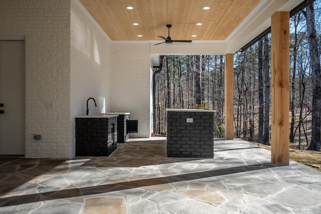 view of patio featuring ceiling fan