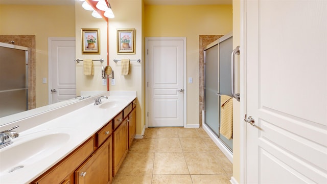 bathroom featuring tile patterned flooring, vanity, and a shower with shower door