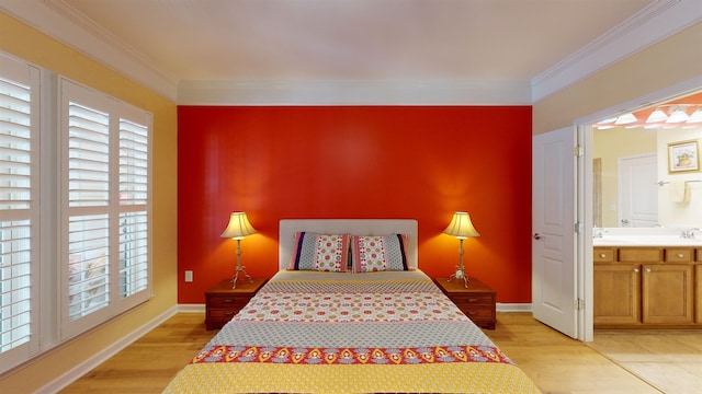 bedroom featuring connected bathroom, crown molding, and light hardwood / wood-style floors