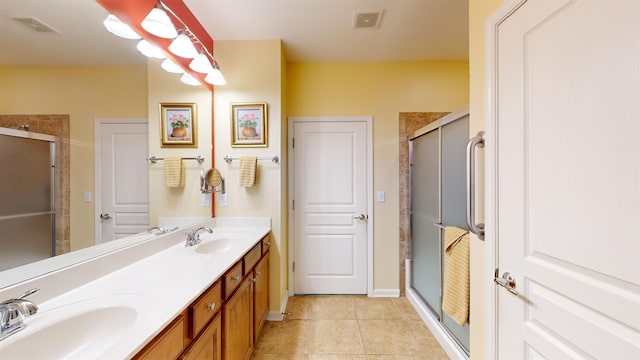 bathroom with tile patterned flooring, vanity, and a shower with shower door