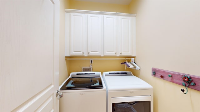 laundry area with cabinets and separate washer and dryer