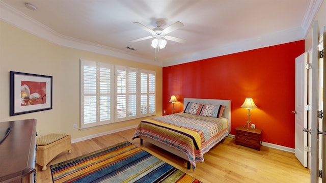 bedroom featuring crown molding, ceiling fan, and light hardwood / wood-style flooring