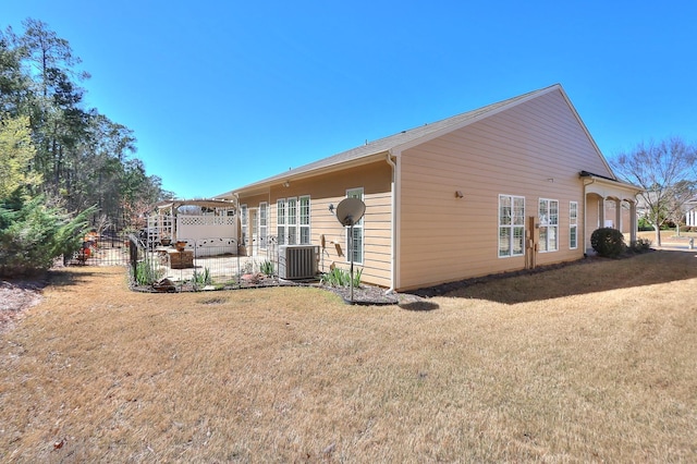 view of side of home with central AC unit, a patio area, and a lawn