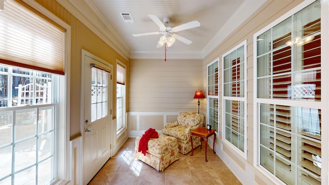 sunroom featuring ceiling fan