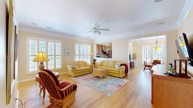 living room with crown molding, light hardwood / wood-style floors, and ceiling fan