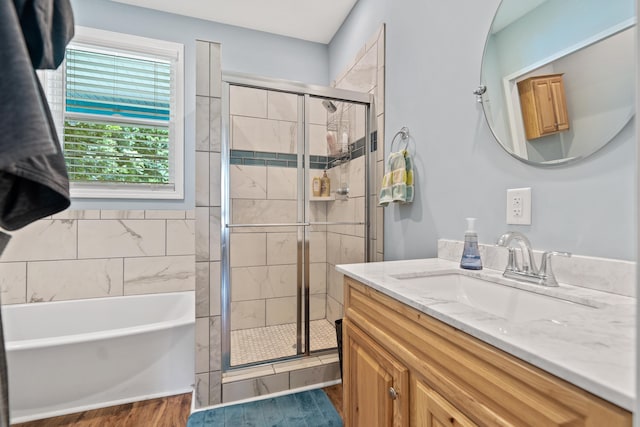 138B Little River Run, Eatonton, GA 31024 - bathroom with vanity, a shower stall, a tub, and wood finished floors