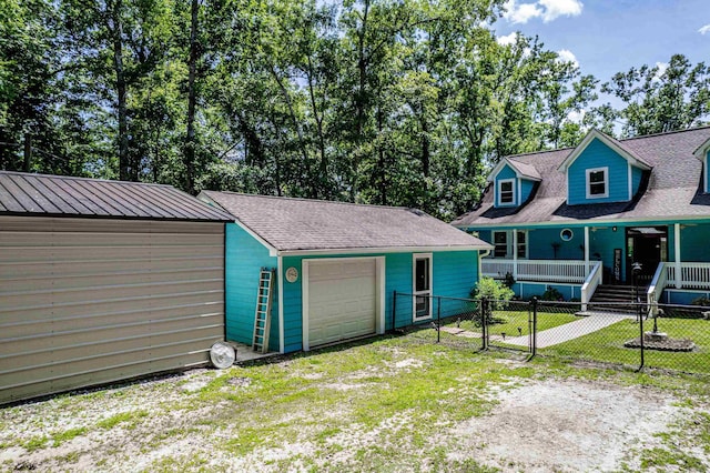 138B Little River Run, Eatonton, GA 31024 - view of front of home with dirt driveway, an outbuilding, an attached garage, and a porch