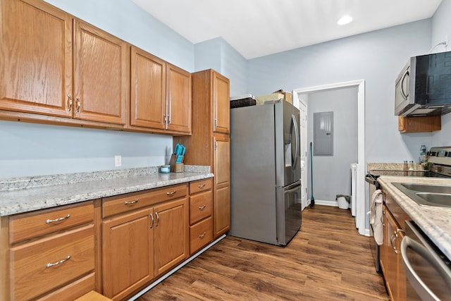 138B Little River Run, Eatonton, GA 31024 - kitchen featuring appliances with stainless steel finishes, dark wood-type flooring, electric panel, brown cabinetry, and recessed lighting