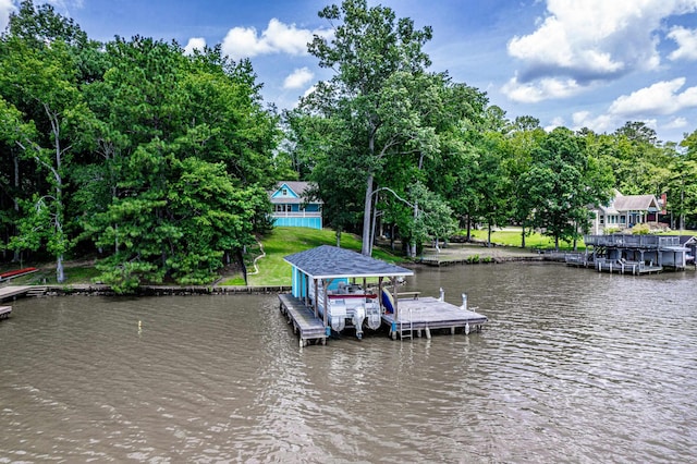 138B Little River Run, Eatonton, GA 31024 - dock area with boat lift, a water view, view of scattered trees, and a yard