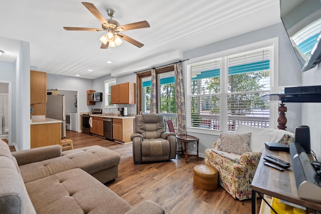 138B Little River Run, Eatonton, GA 31024 - living room with washer / dryer, light wood-type flooring, and a ceiling fan