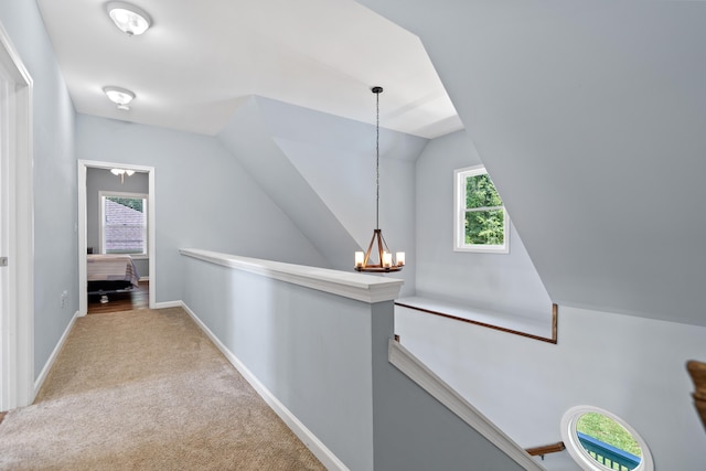 138B Little River Run, Eatonton, GA 31024 - corridor featuring an upstairs landing, carpet flooring, vaulted ceiling, and a chandelier