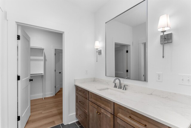 1731 Osprey Poynte, Greensboro, GA 30642 - bathroom featuring baseboards, wood finished floors, and vanity