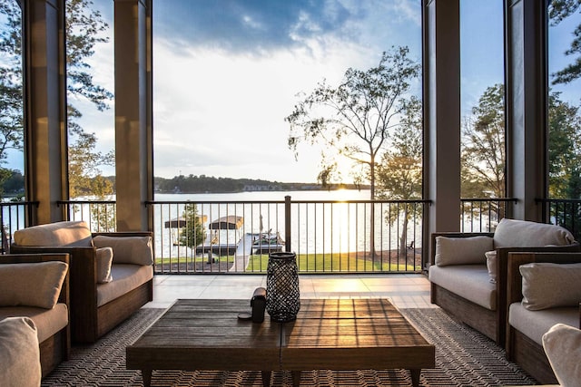 balcony with a water view and an outdoor living space