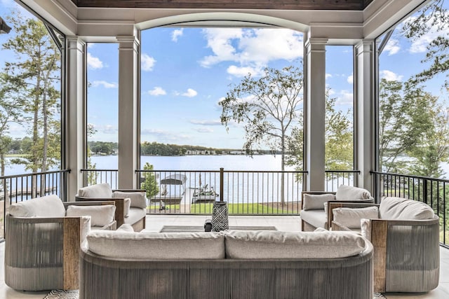 wooden terrace featuring a water view and an outdoor living space