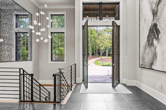 entrance foyer featuring baseboards and tile patterned floors