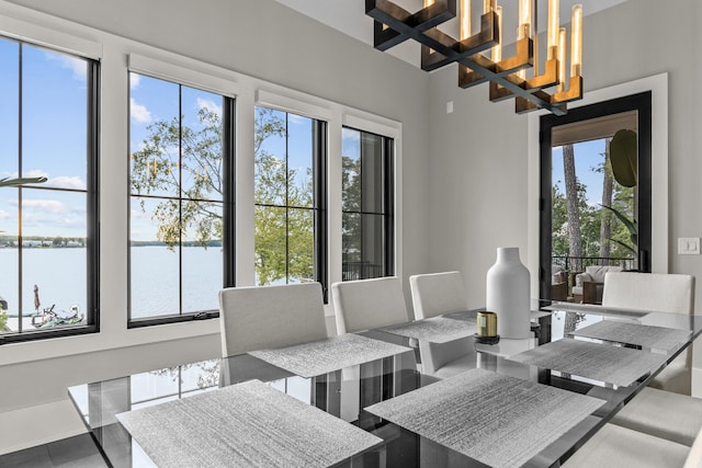 dining room with a water view and an inviting chandelier