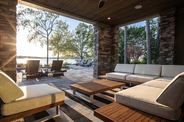 view of patio with a water view and outdoor lounge area