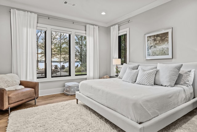 bedroom with recessed lighting, wood finished floors, visible vents, and baseboards