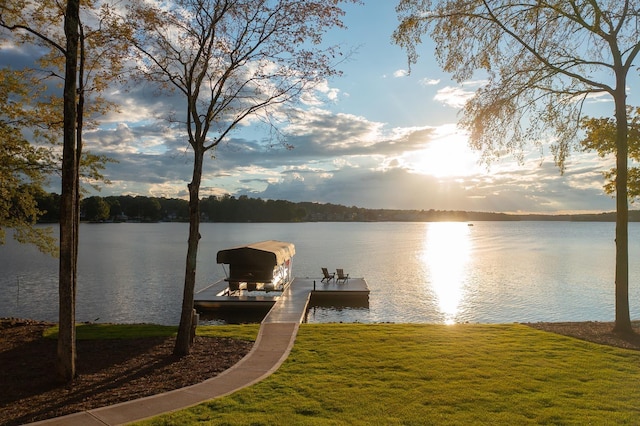 dock area featuring a water view and a yard