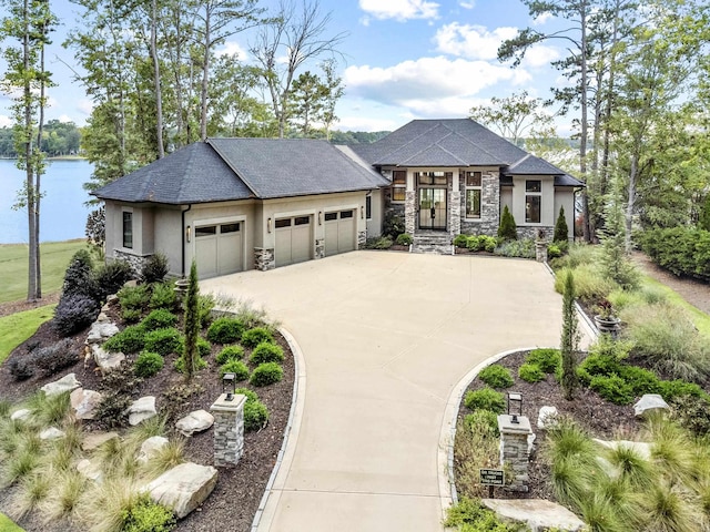 prairie-style home featuring a garage, stone siding, concrete driveway, and stucco siding