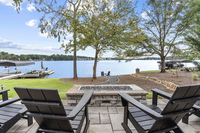 view of patio with a water view, a boat dock, and a fire pit