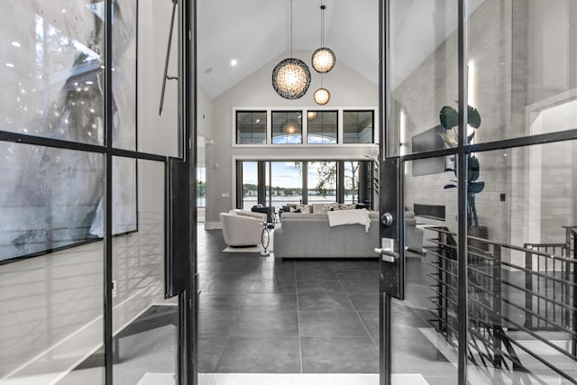 gym featuring high vaulted ceiling and tile patterned flooring