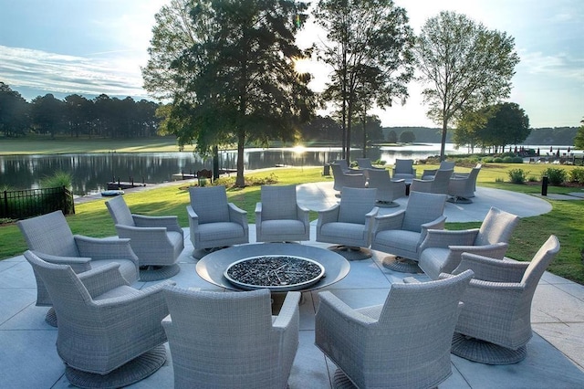 view of patio / terrace featuring a water view and a fire pit