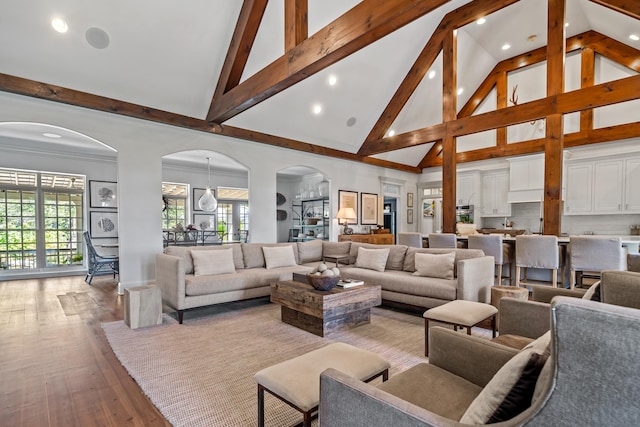 living room featuring high vaulted ceiling, beam ceiling, and light hardwood / wood-style floors