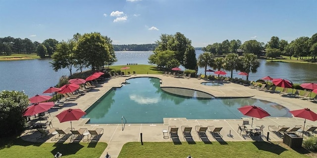 view of swimming pool with a lawn, a patio, and a water view