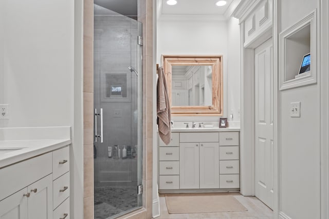 bathroom with vanity, ornamental molding, and walk in shower