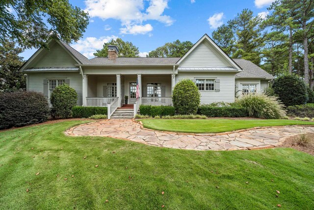 view of front of property with a porch and a front lawn