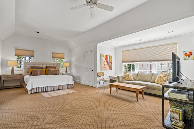 carpeted bedroom with vaulted ceiling and ceiling fan