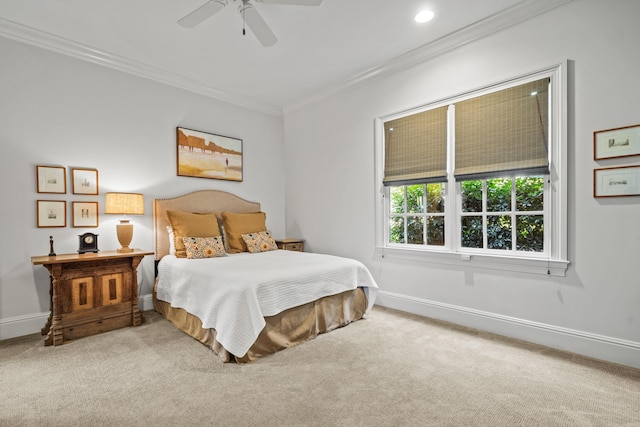 carpeted bedroom with ceiling fan and ornamental molding