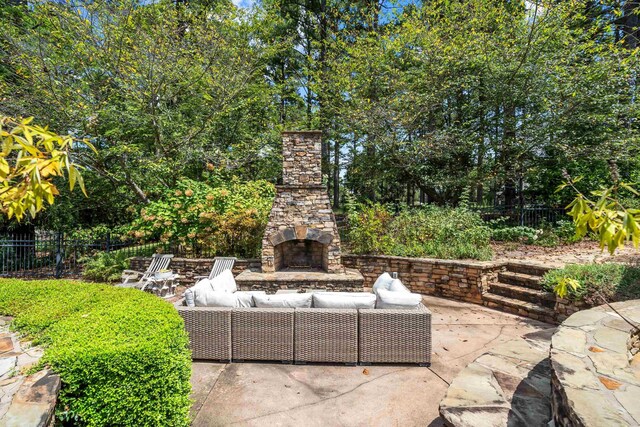 view of patio / terrace with an outdoor living space with a fireplace