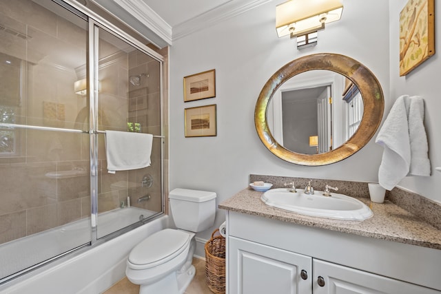 full bathroom with ornamental molding, vanity, bath / shower combo with glass door, and toilet