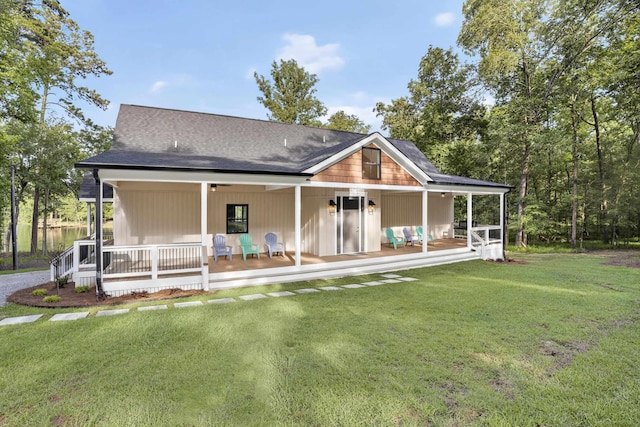 1005 Dennis St, Eatonton, GA 31024 - rear view of house with a porch, a yard, and a shingled roof