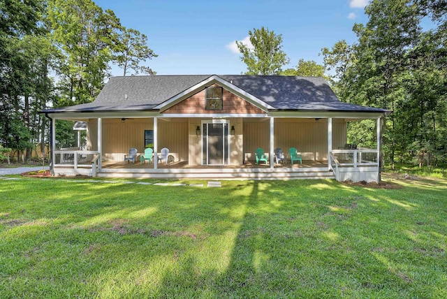 1005 Dennis St, Eatonton, GA 31024 - rear view of property featuring a porch, a lawn, and roof with shingles